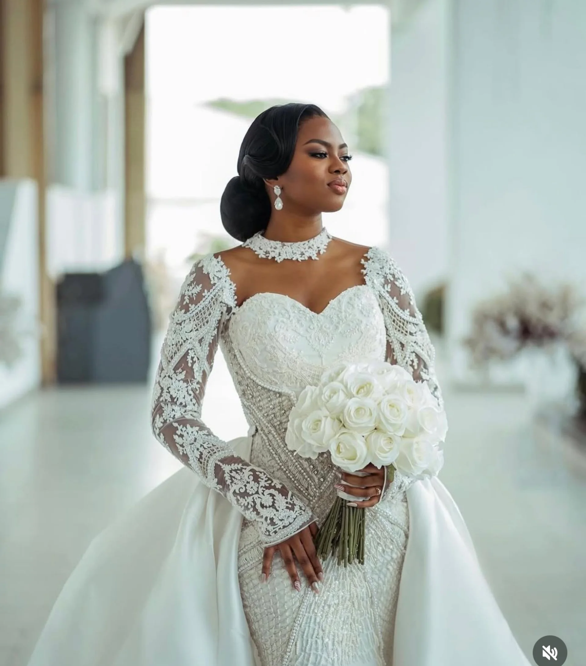 Model wearing a structured white bridal gown